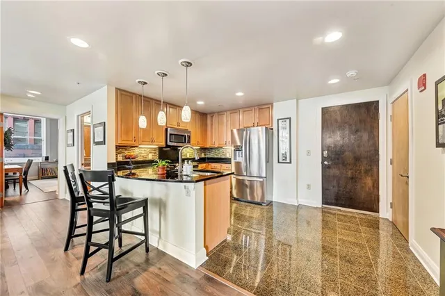 a kitchen with stainless steel appliances granite countertop counter space a large cabinets and living room view