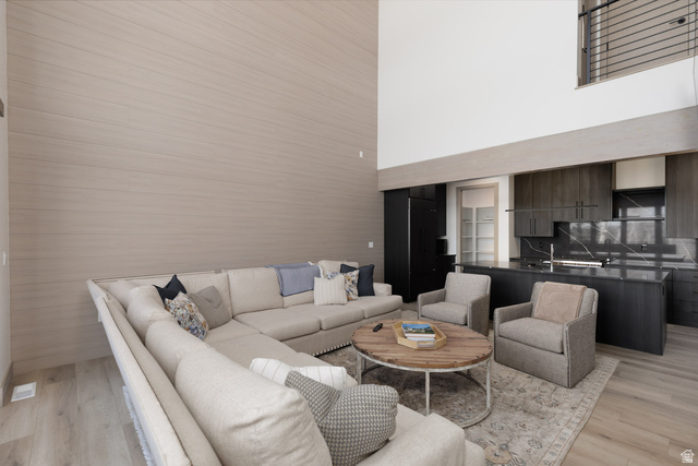 160 Ridgeview Street, Unit 7B Brian Head, UT 84719 - Photo 9 of 40 Living area featuring a high ceiling and light wood-style floors