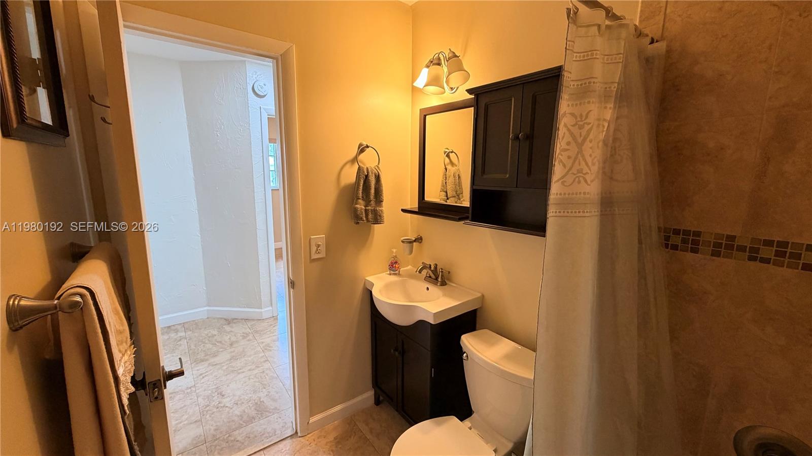 4161 Southwest 97th Place Miami, FL 33165 - Photo 11 of 19 a bathroom with a sink toilet and shower