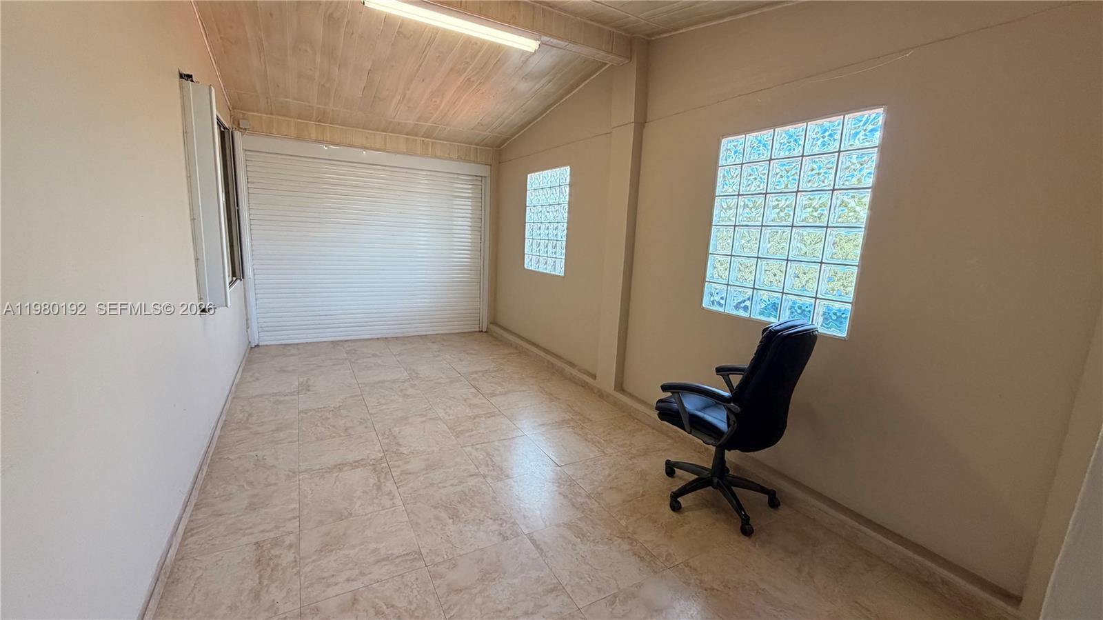 4161 Southwest 97th Place Miami, FL 33165 - Photo 12 of 19 a view of a workspace with furniture and a window