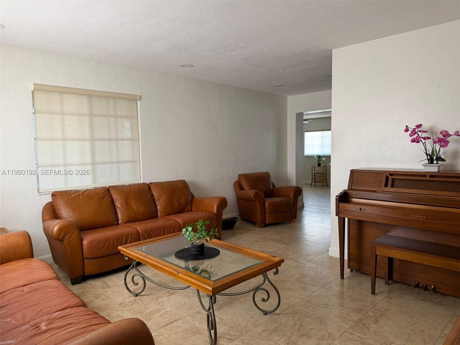 4161 Southwest 97th Place Miami, FL 33165 - Photo 2 of 19 a living room with furniture a rug and a window
