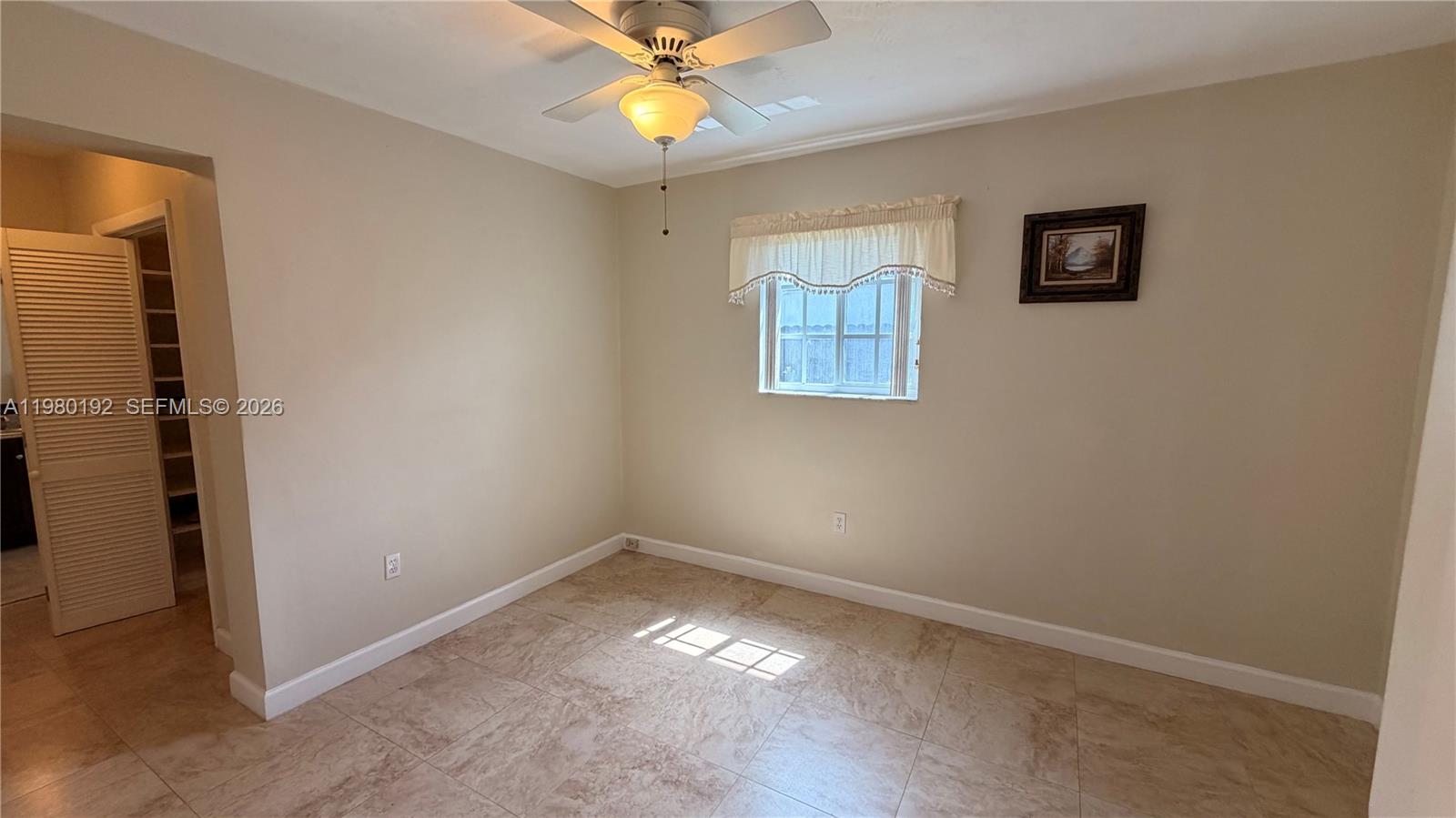 4161 Southwest 97th Place Miami, FL 33165 - Photo 5 of 19 an empty room with windows and fan