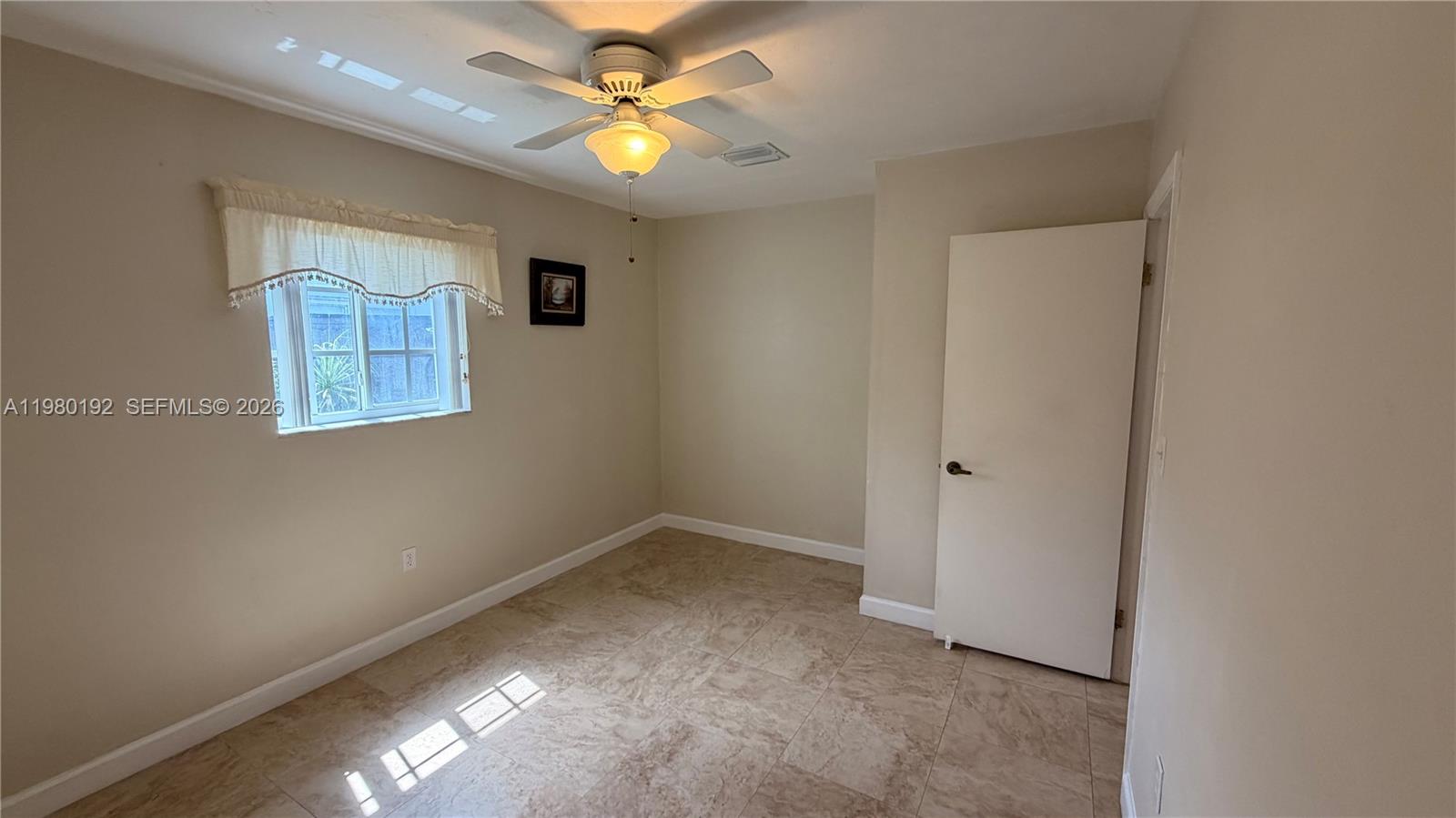 4161 Southwest 97th Place Miami, FL 33165 - Photo 6 of 19 an empty room with windows and fan