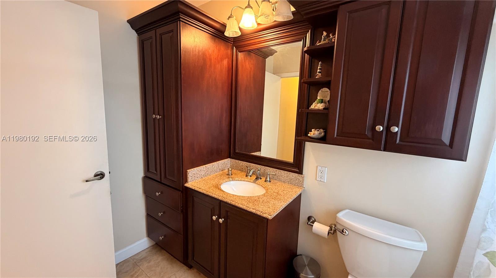 4161 Southwest 97th Place Miami, FL 33165 - Photo 7 of 19 a bathroom with a toilet sink and mirror