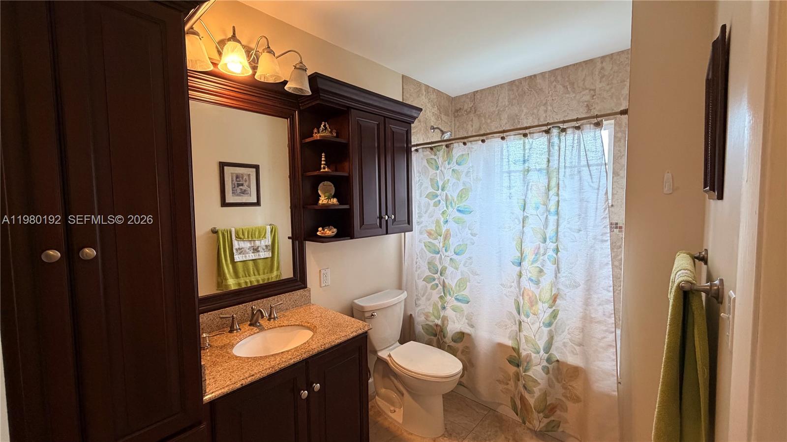 4161 Southwest 97th Place Miami, FL 33165 - Photo 8 of 19 a bathroom with a granite countertop sink toilet and shower