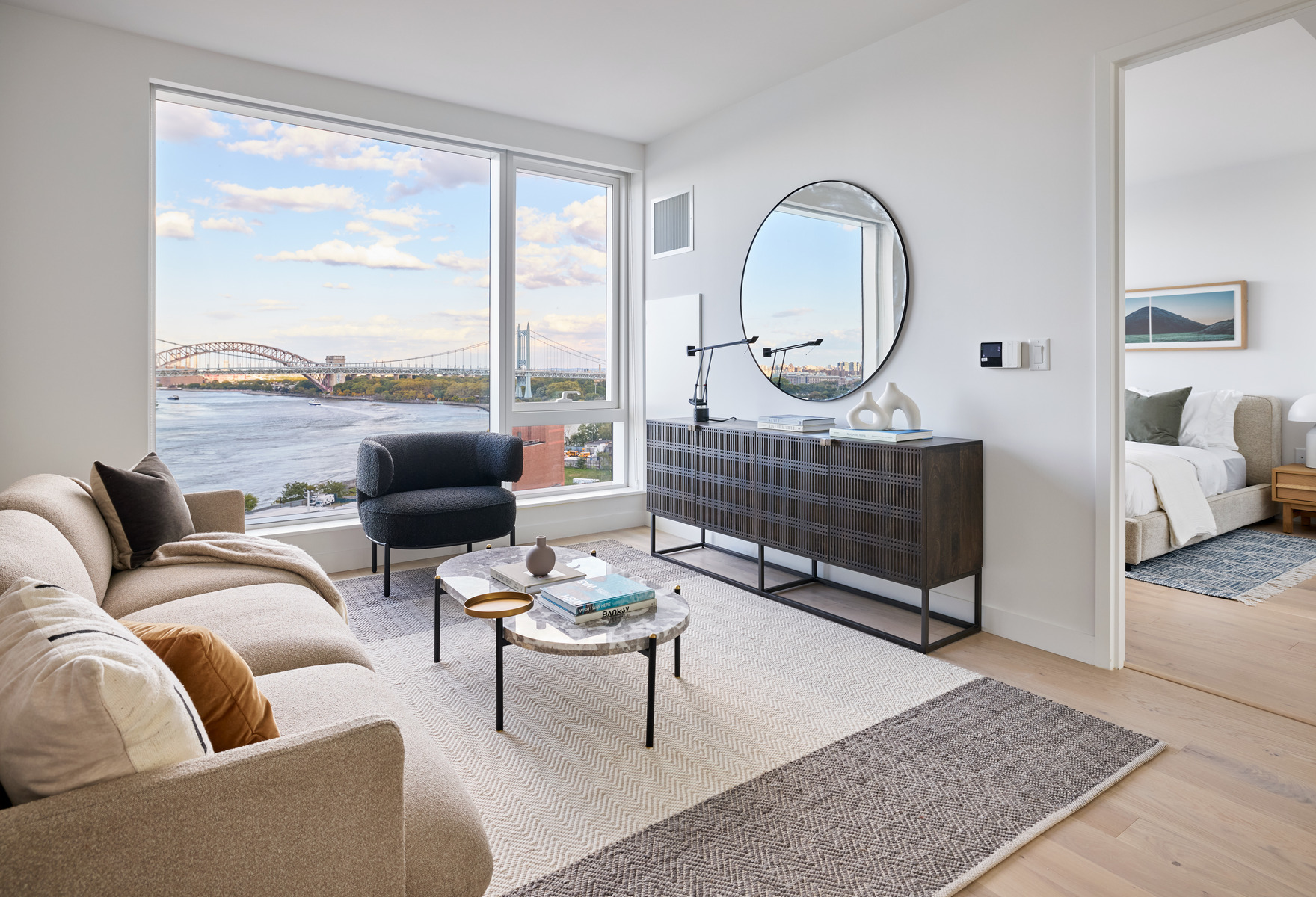 20 Halletts Point, Unit 21205 Queens, NY 11102 - Photo 15 of 46 a living room with furniture a rug a lamp and a large window