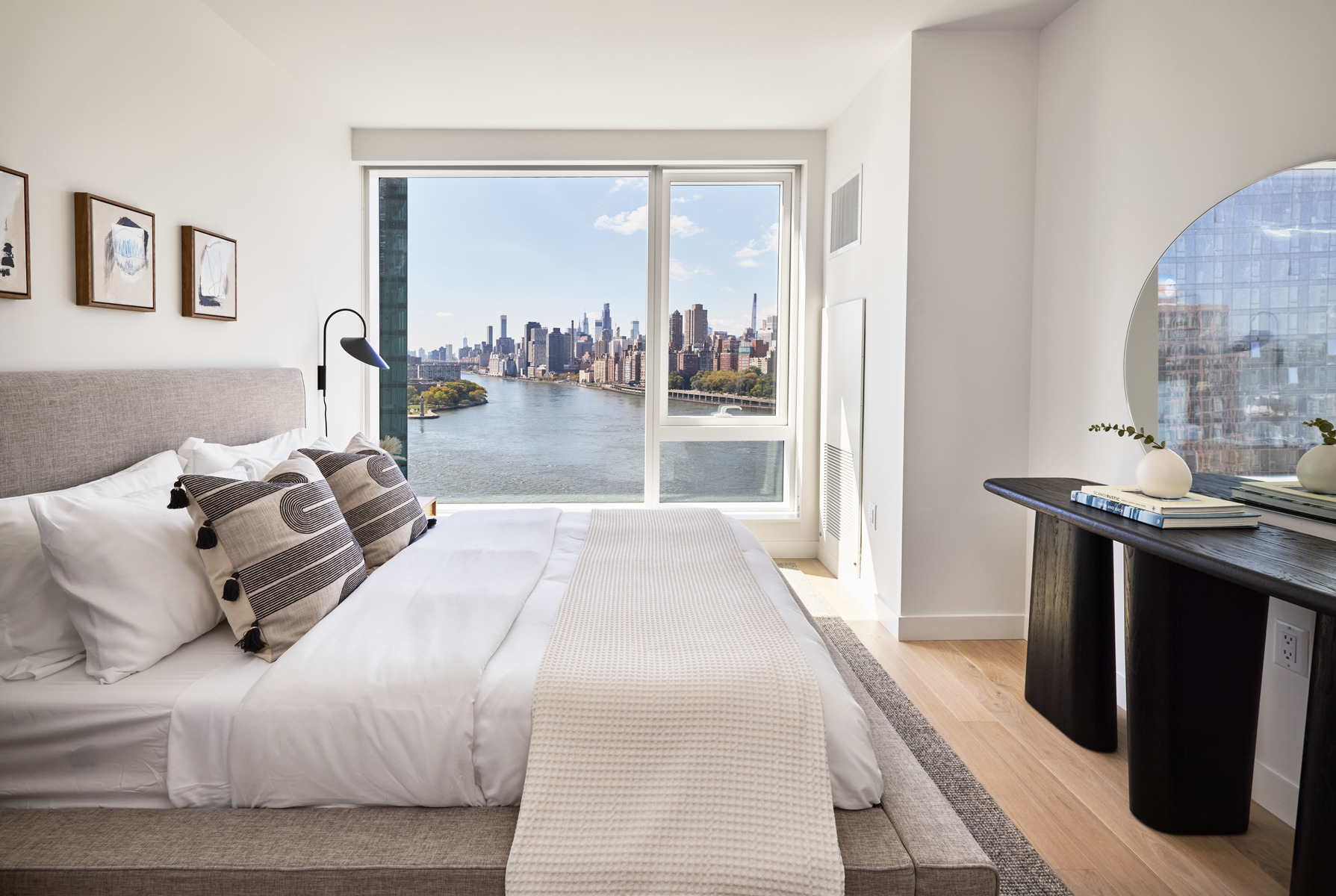 20 Halletts Point, Unit 21205 Queens, NY 11102 - Photo 16 of 46 a bedroom with a bed and a mirror