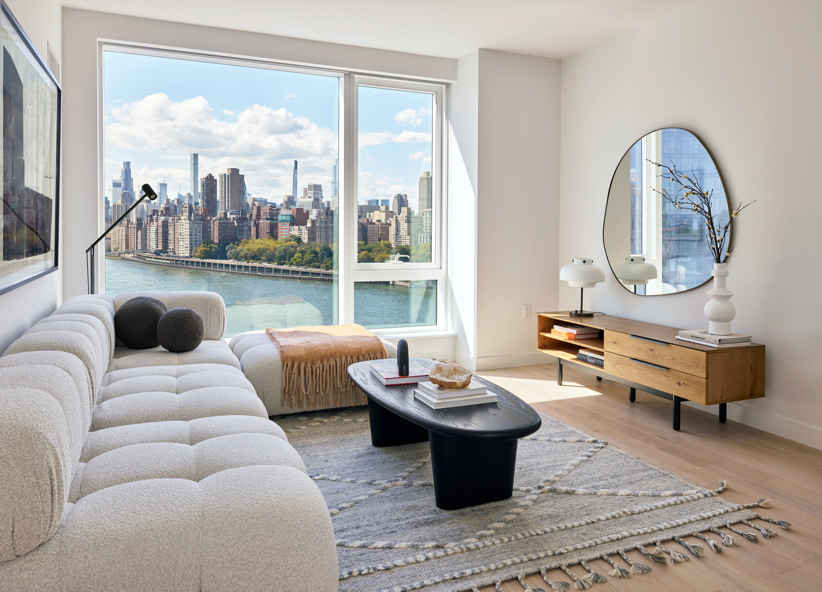 20 Halletts Point, Unit 21205 Queens, NY 11102 - Photo 17 of 46 a living room with furniture a rug a lamp and a large window