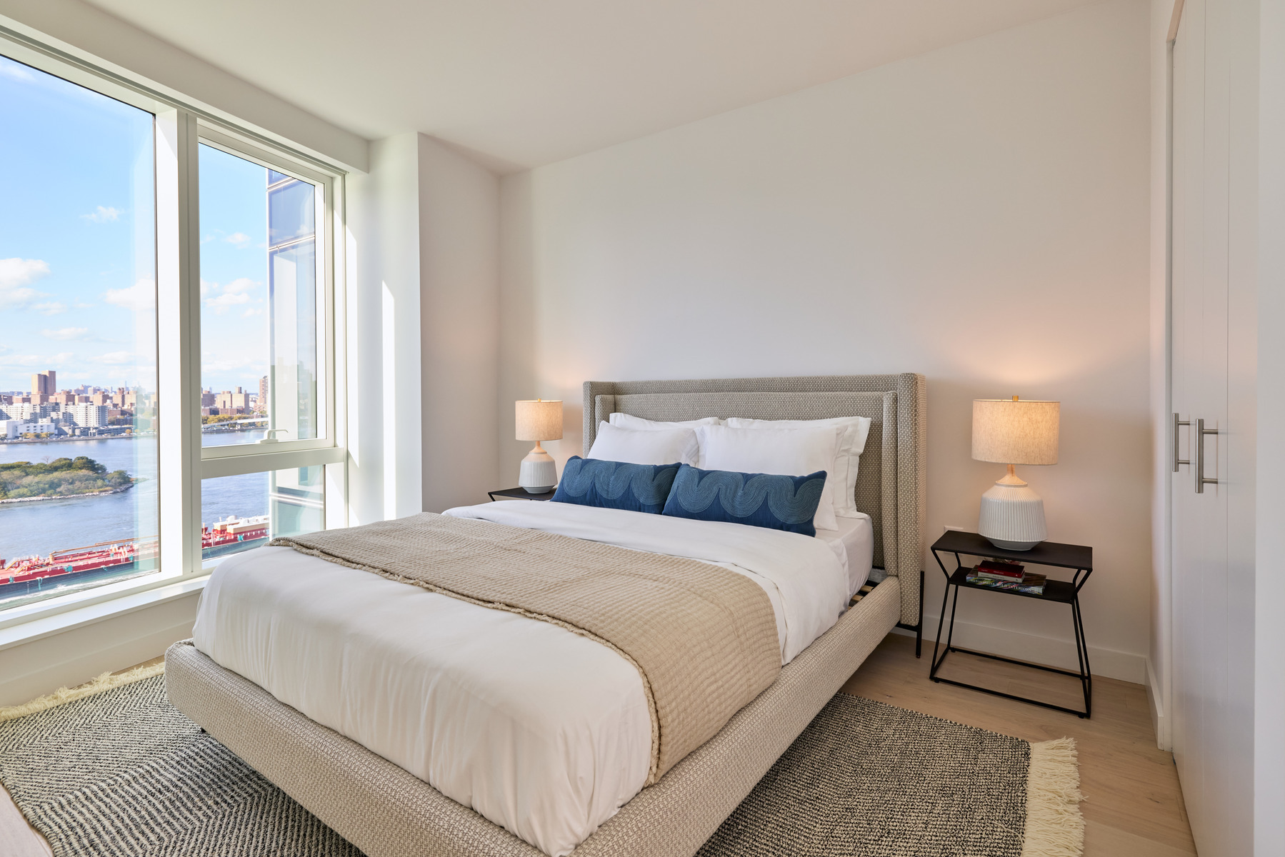 20 Halletts Point, Unit 21205 Queens, NY 11102 - Photo 21 of 46 a large bed sitting in a bedroom next to a window