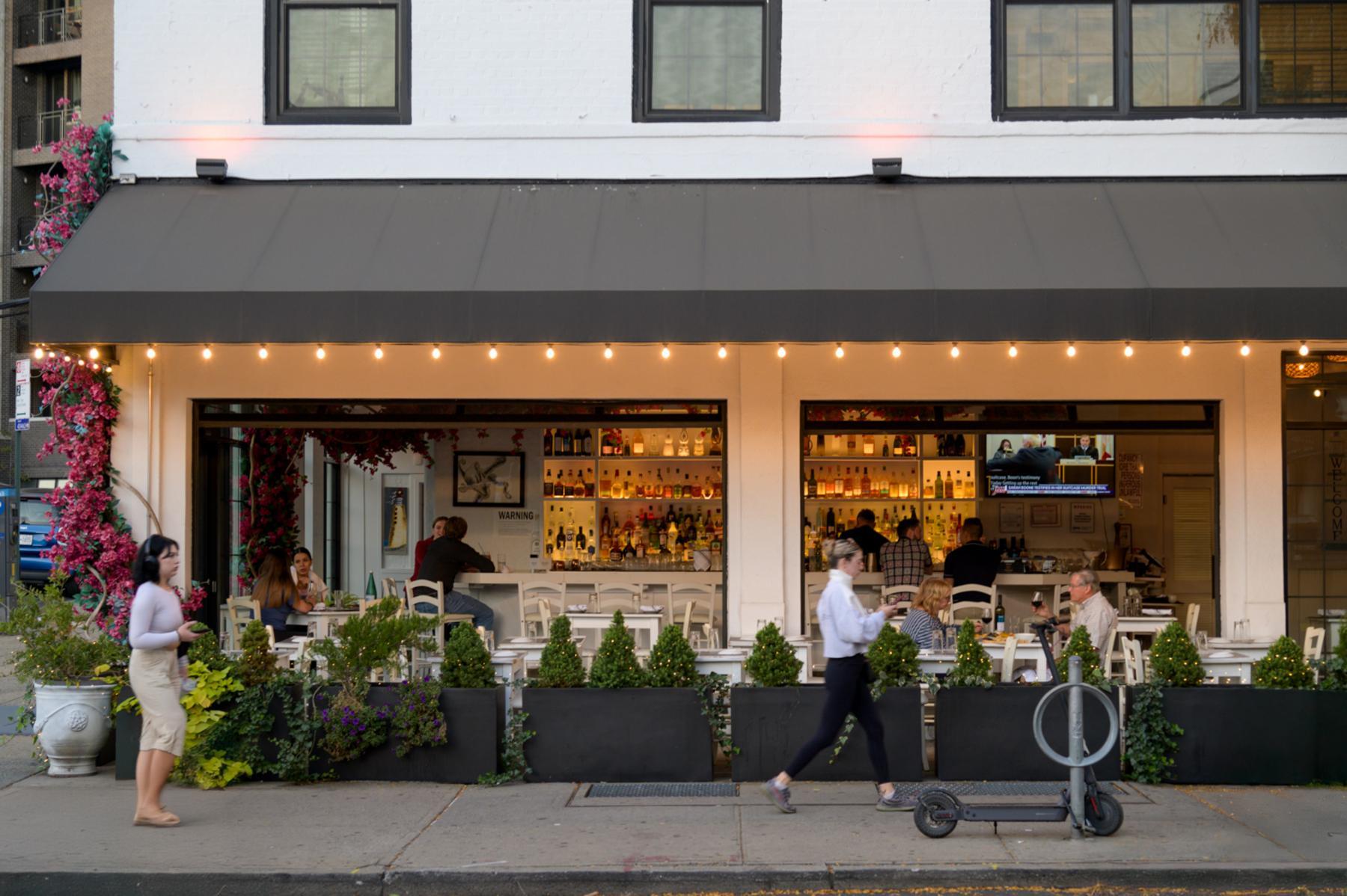 20 Halletts Point, Unit 21205 Queens, NY 11102 - Photo 44 of 46 a front view of a building with lots of potted plants