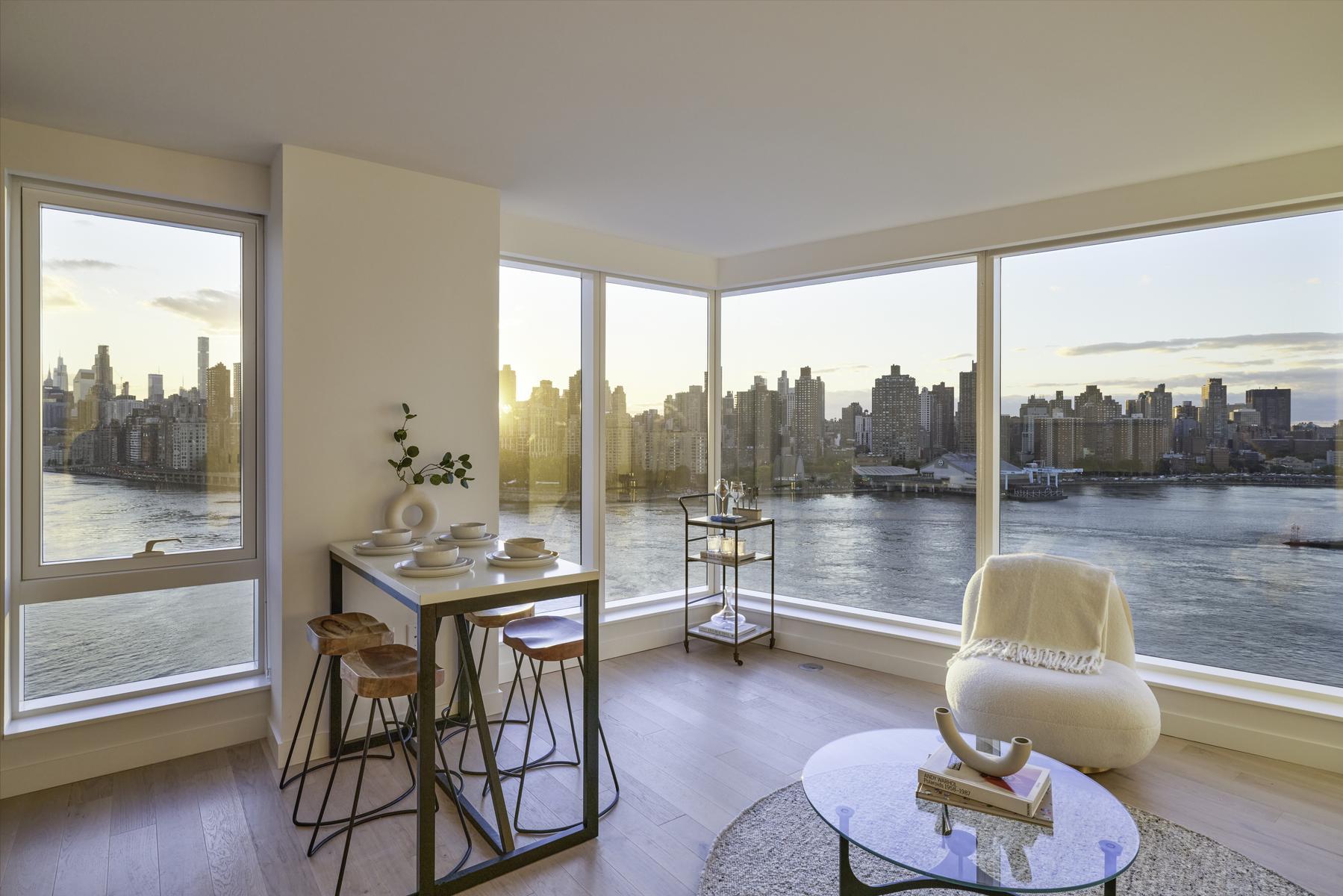 20 Halletts Point, Unit 21205 Queens, NY 11102 - Photo 9 of 46 a living room with furniture and a floor to ceiling window