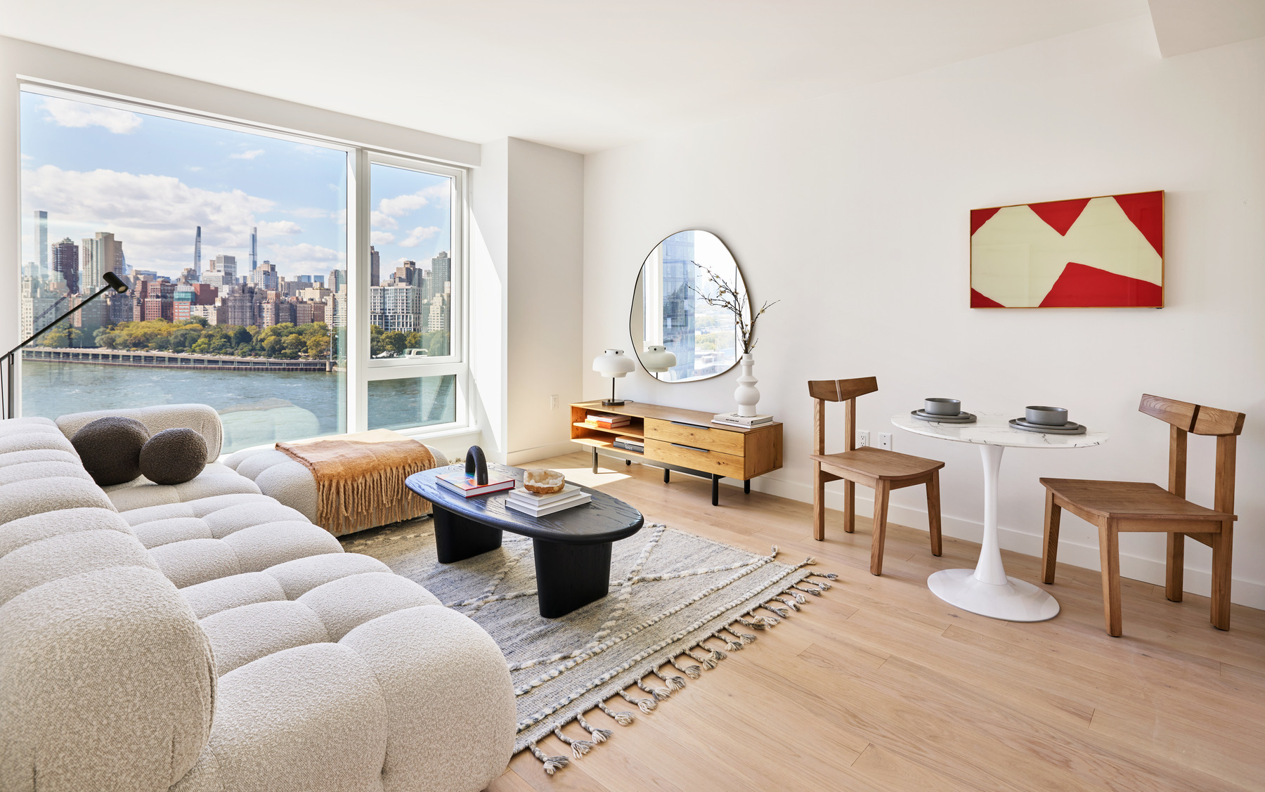 20 Halletts Point, Unit 21205 Queens, NY 11102 - Photo 10 of 46 a living room with furniture a rug and a floor to ceiling window