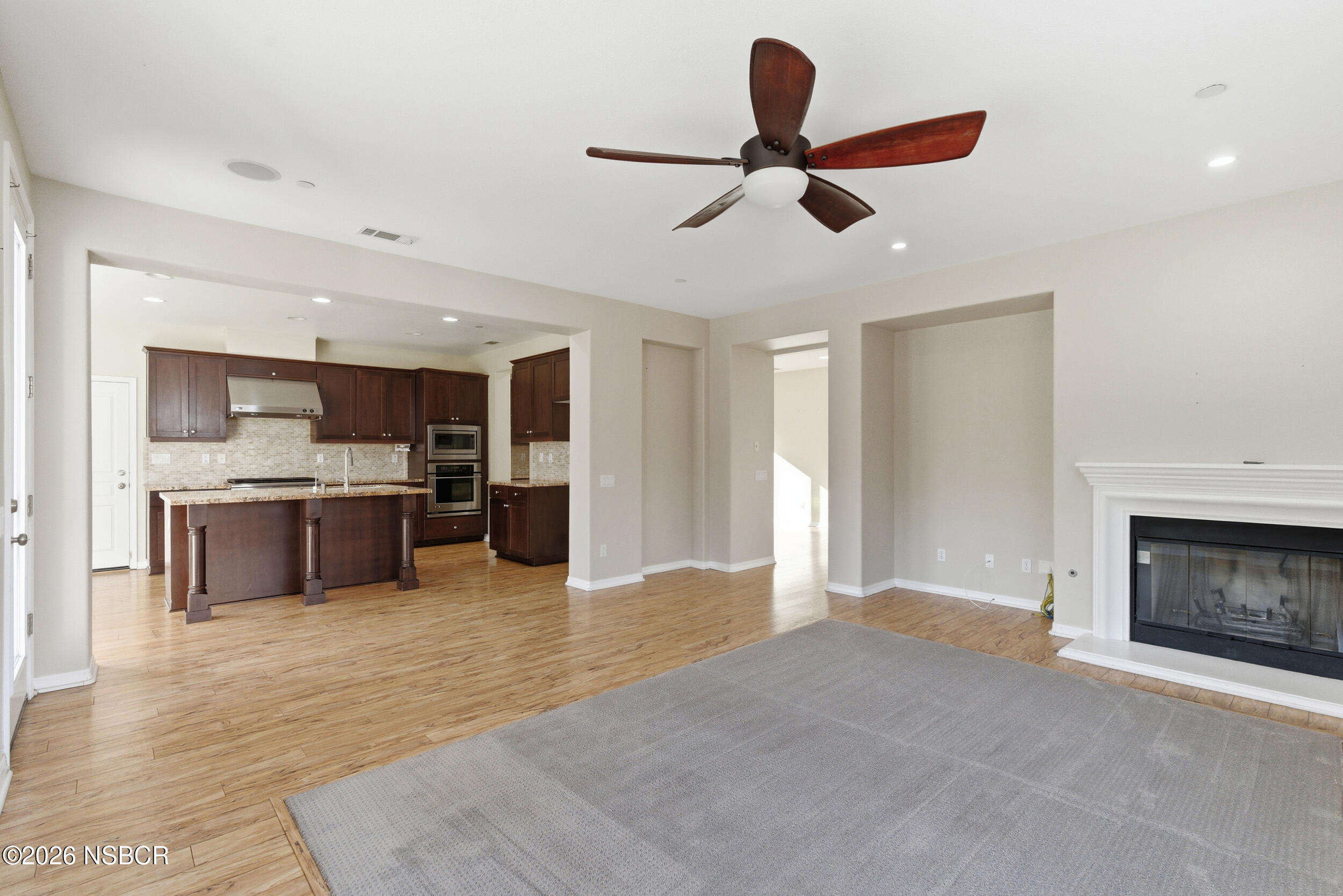 5632 Menemsha Lane Santa Maria, CA 93455 - Photo 15 of 66 a living room with stainless steel appliances kitchen island furniture and a fireplace