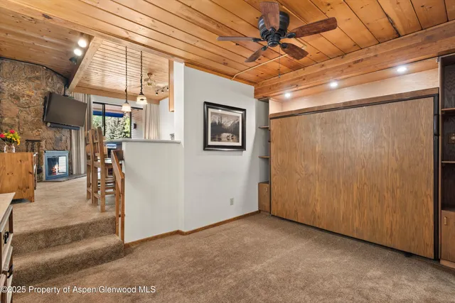 a view of a livingroom with wooden floor and windows