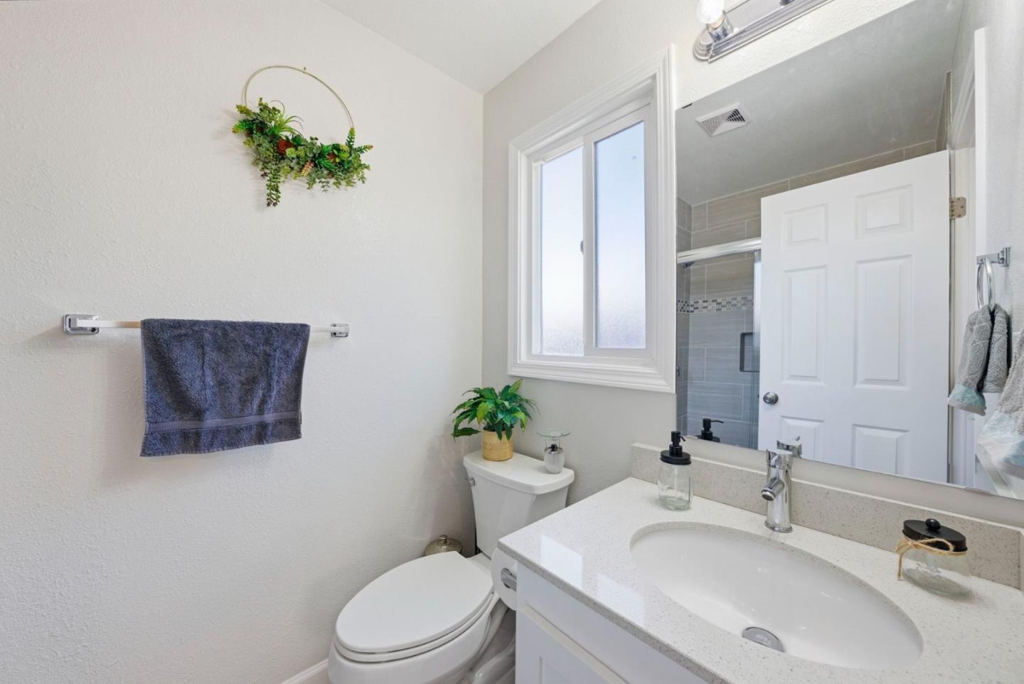 2793 Ruff Court Pinole, CA 94564 - Photo 31 of 53 a bathroom with a sink a toilet and a mirror