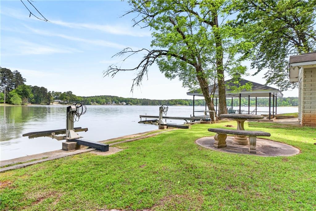 149 Pine Bluff Trail Jackson, GA 30233 - Photo 20 of 59 a view of a swimming pool with a table and chairs in a patio