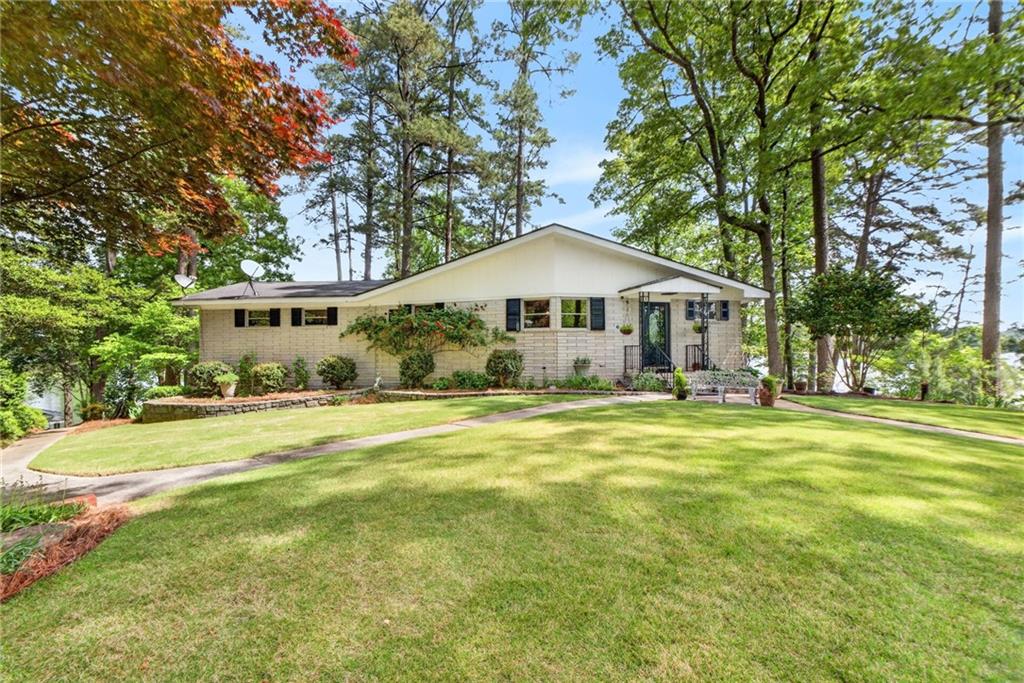 149 Pine Bluff Trail Jackson, GA 30233 - Photo 24 of 59 a front view of a house with a yard and trees