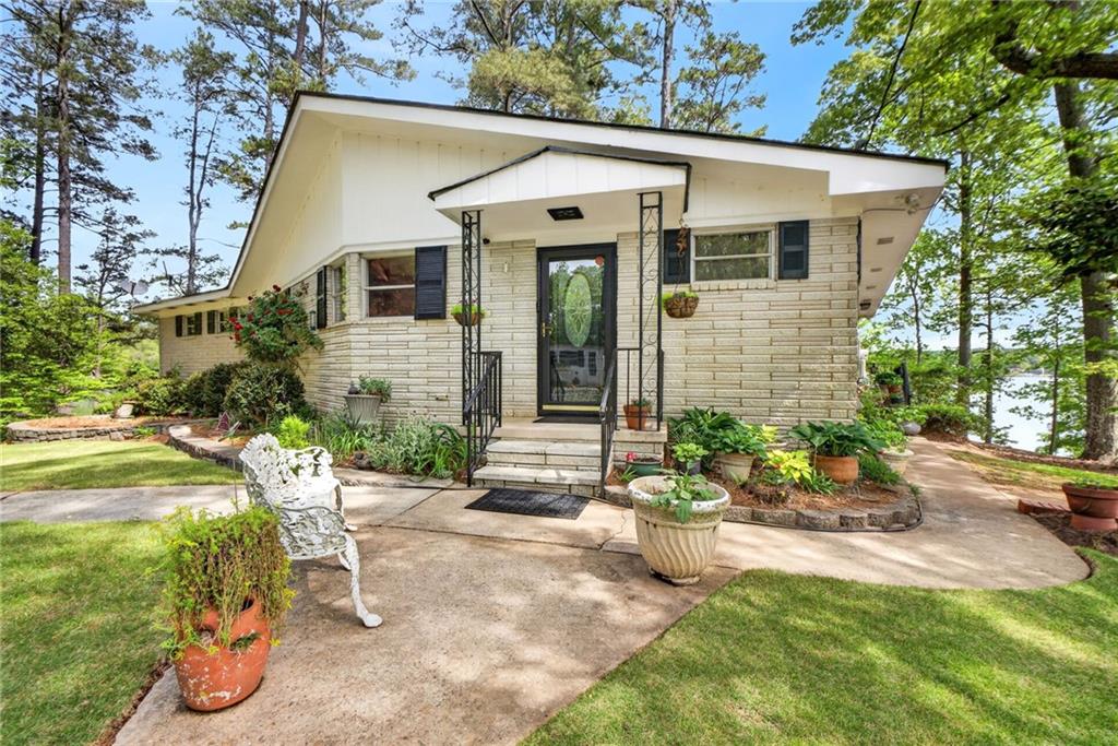 149 Pine Bluff Trail Jackson, GA 30233 - Photo 25 of 59 a front view of a house with a yard and potted plants