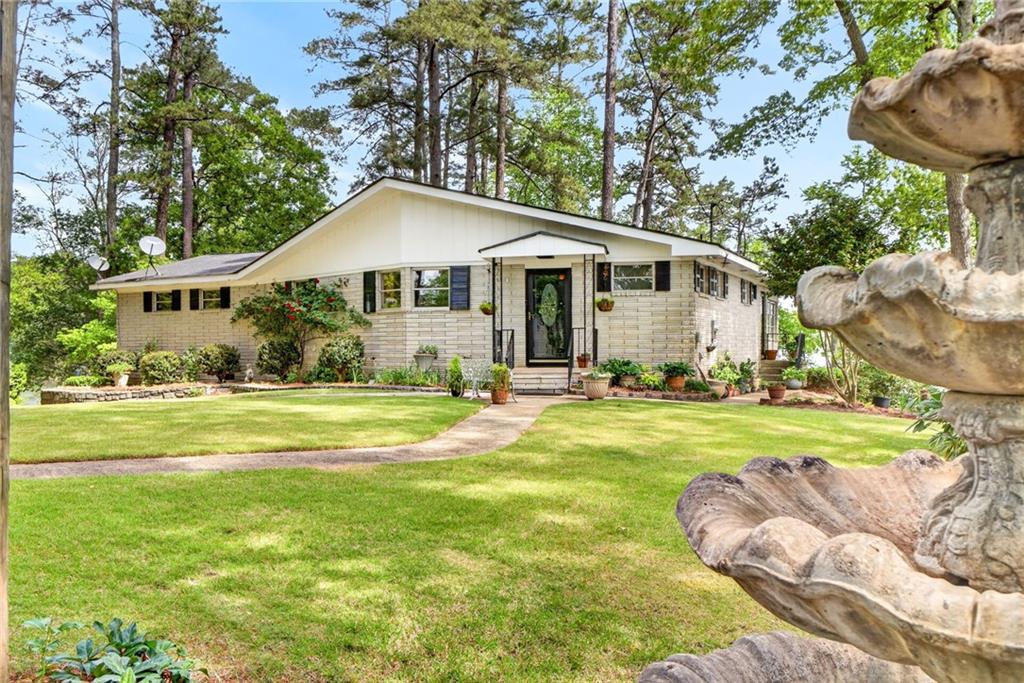 149 Pine Bluff Trail Jackson, GA 30233 - Photo 3 of 59 a view of a house with a yard patio and deck