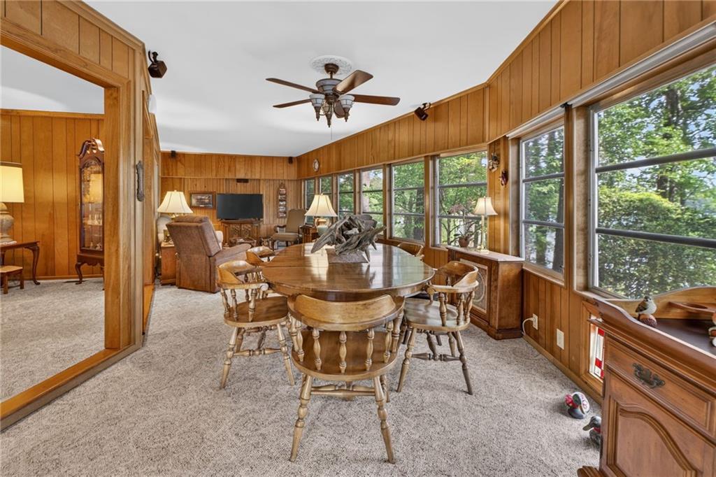 149 Pine Bluff Trail Jackson, GA 30233 - Photo 35 of 59 a dining room with furniture a fireplace and a large window