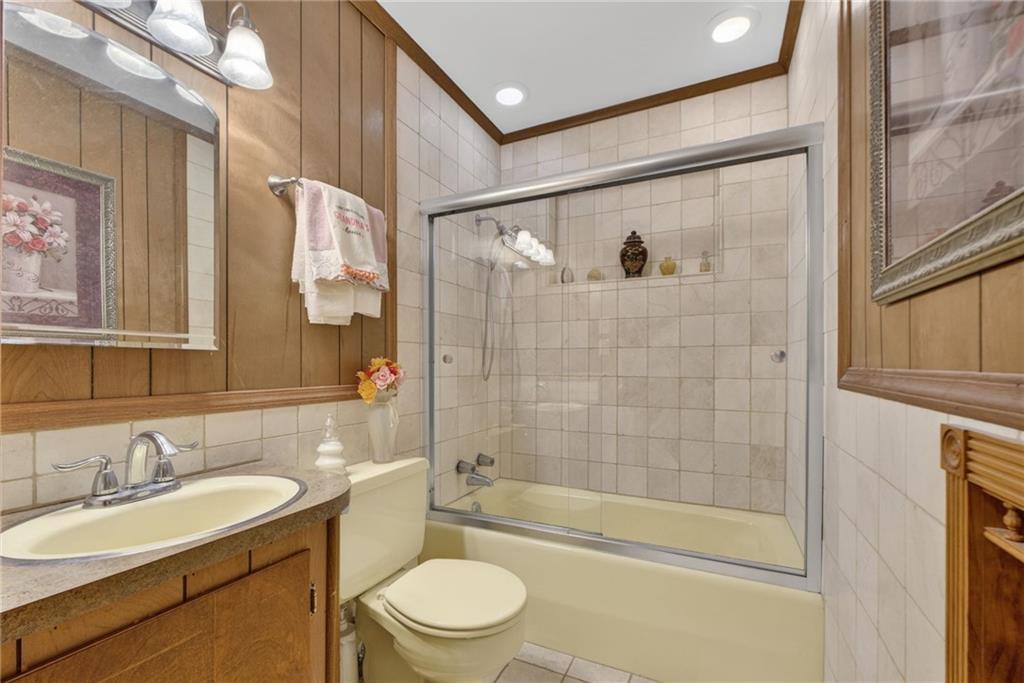149 Pine Bluff Trail Jackson, GA 30233 - Photo 42 of 59 a bathroom with a granite countertop sink a mirror a bathtub and shower