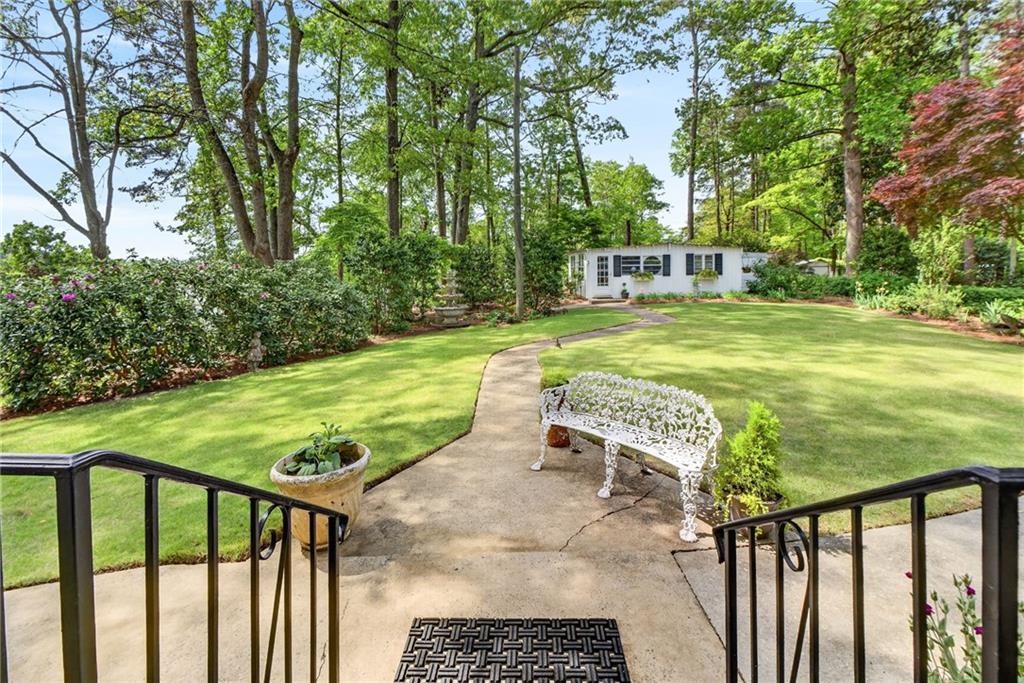 149 Pine Bluff Trail Jackson, GA 30233 - Photo 49 of 59 a view of a swimming pool with lawn chairs and plants