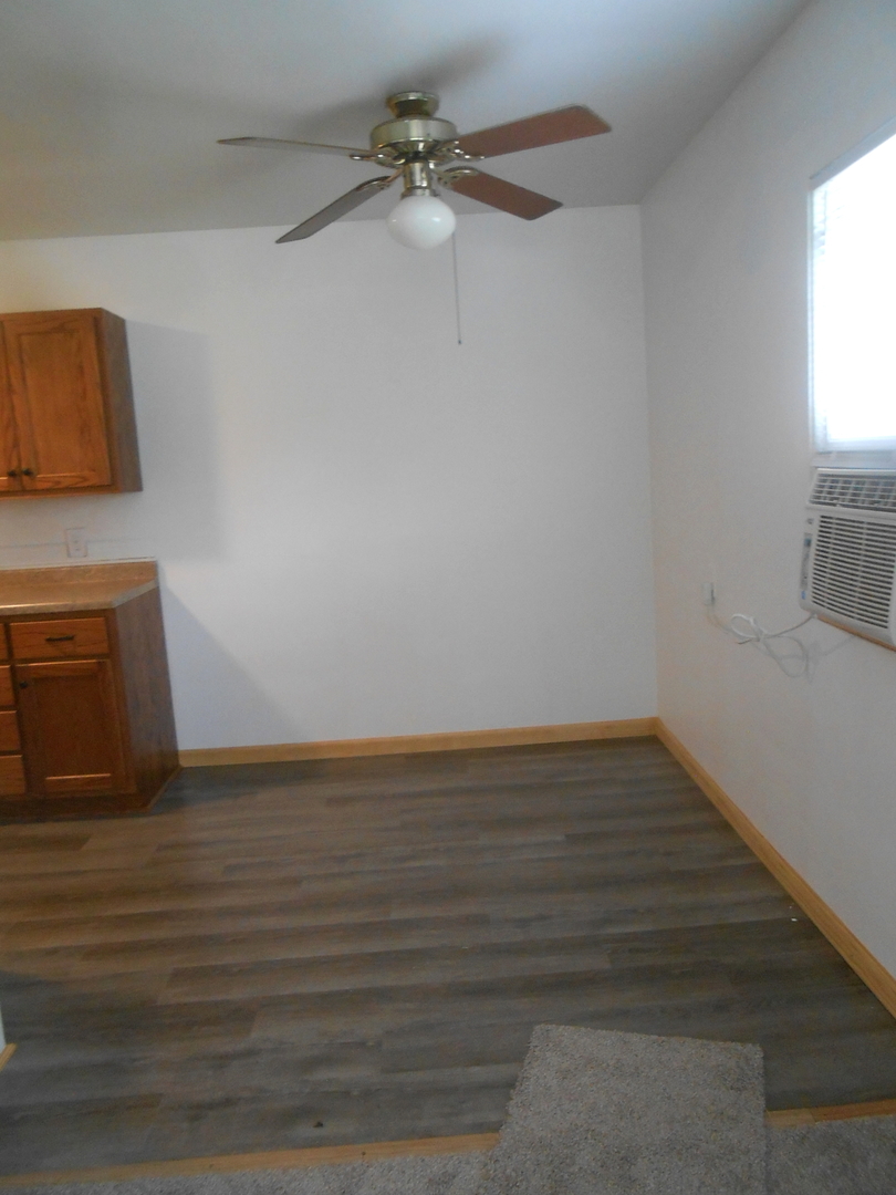 1955-65 West Southmor Road Morris, IL 60450 - Photo 4 of 12 a view of an empty room with wooden floor and a window