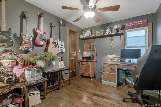 a view of a workspace with furniture and a kitchen