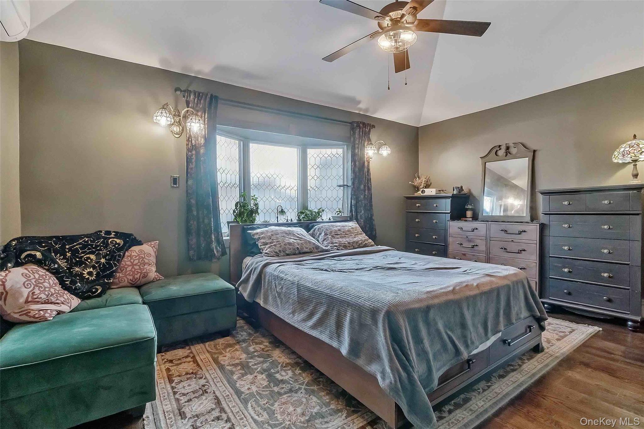 27 West 11th Road Queens, NY 11693 - Photo 15 of 18 a bedroom with a bed couch and window