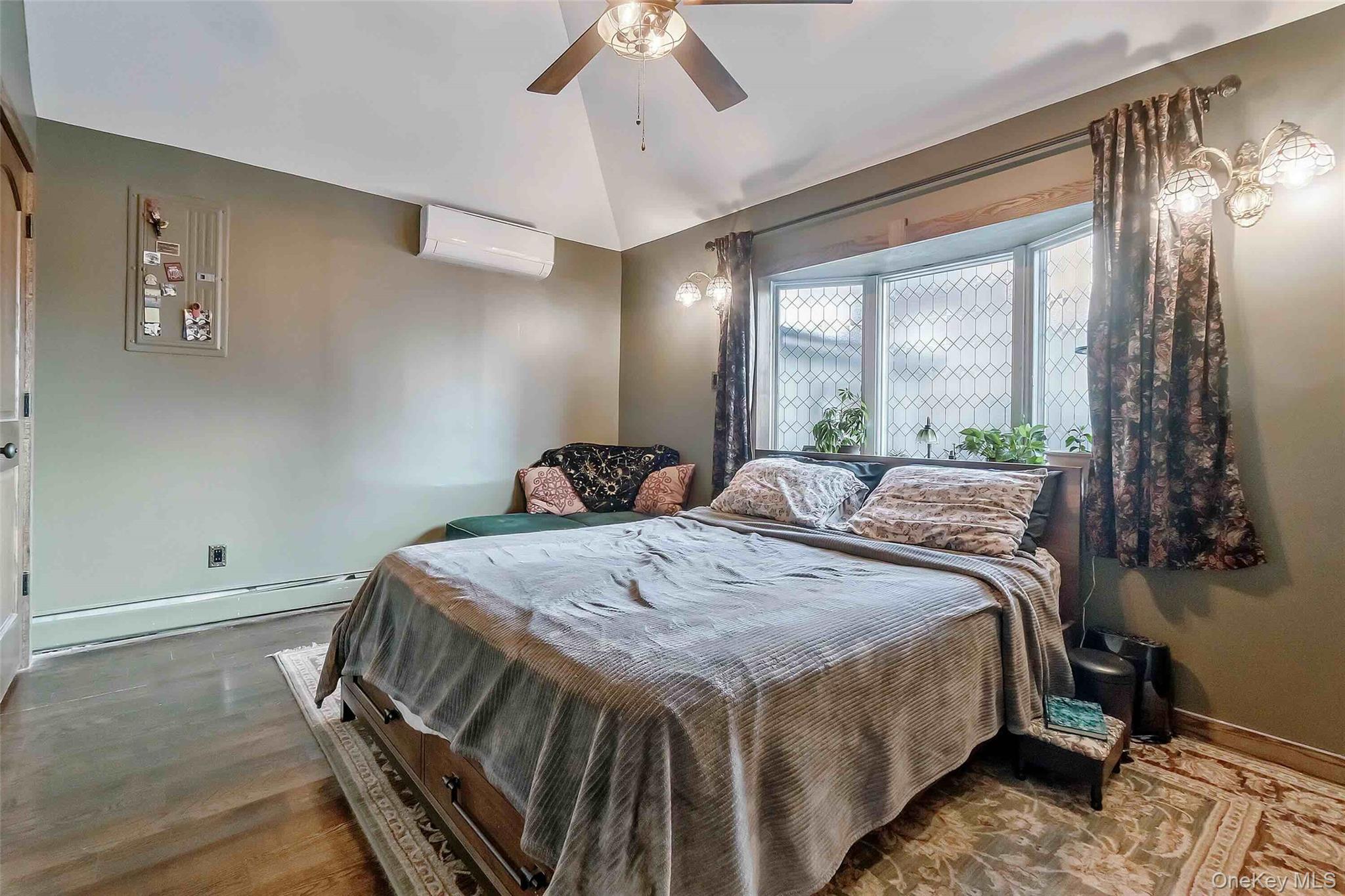 27 West 11th Road Queens, NY 11693 - Photo 16 of 18 a bed sitting in a bedroom next to a window