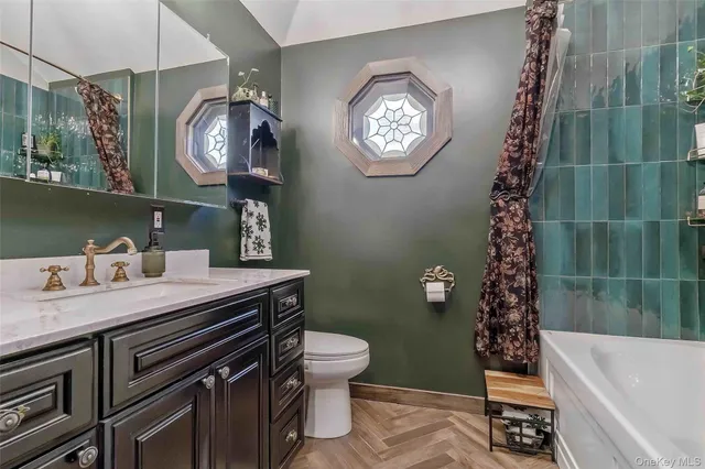 a bathroom with a sink a toilet and a mirror