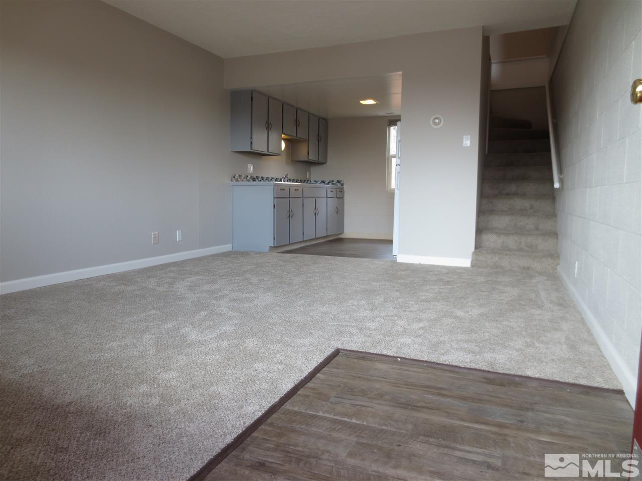 2133 Patton Drive Reno, NV 89512 - Photo 7 of 23 an empty room with wooden floor and windows