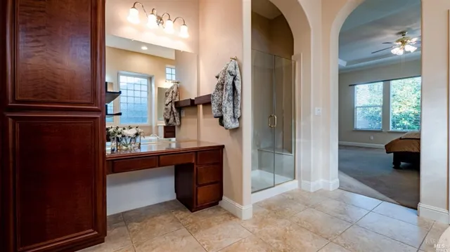 a view of a hallway and a livingroom with furniture