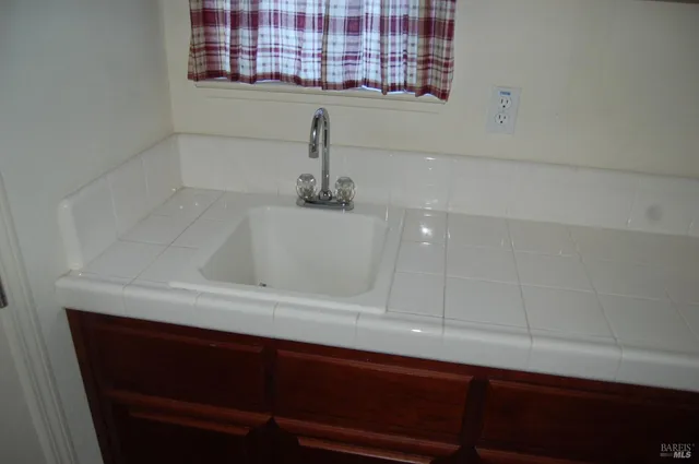 a bathroom with a sink and a window