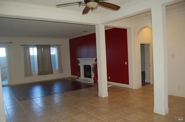 a view of empty room with fireplace and wooden floor
