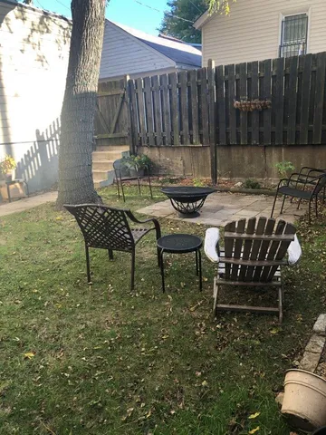 a view of a chairs and table in backyard