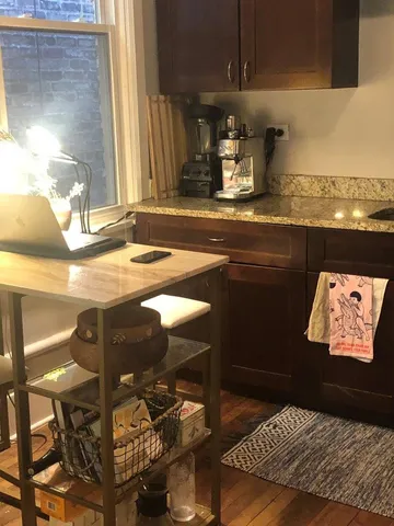 a kitchen with a sink a stove and chairs