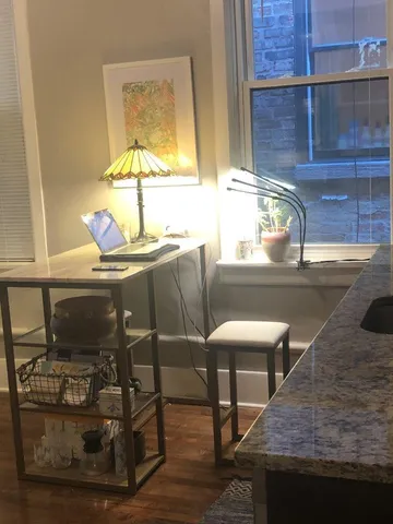 a dining room with furniture and window