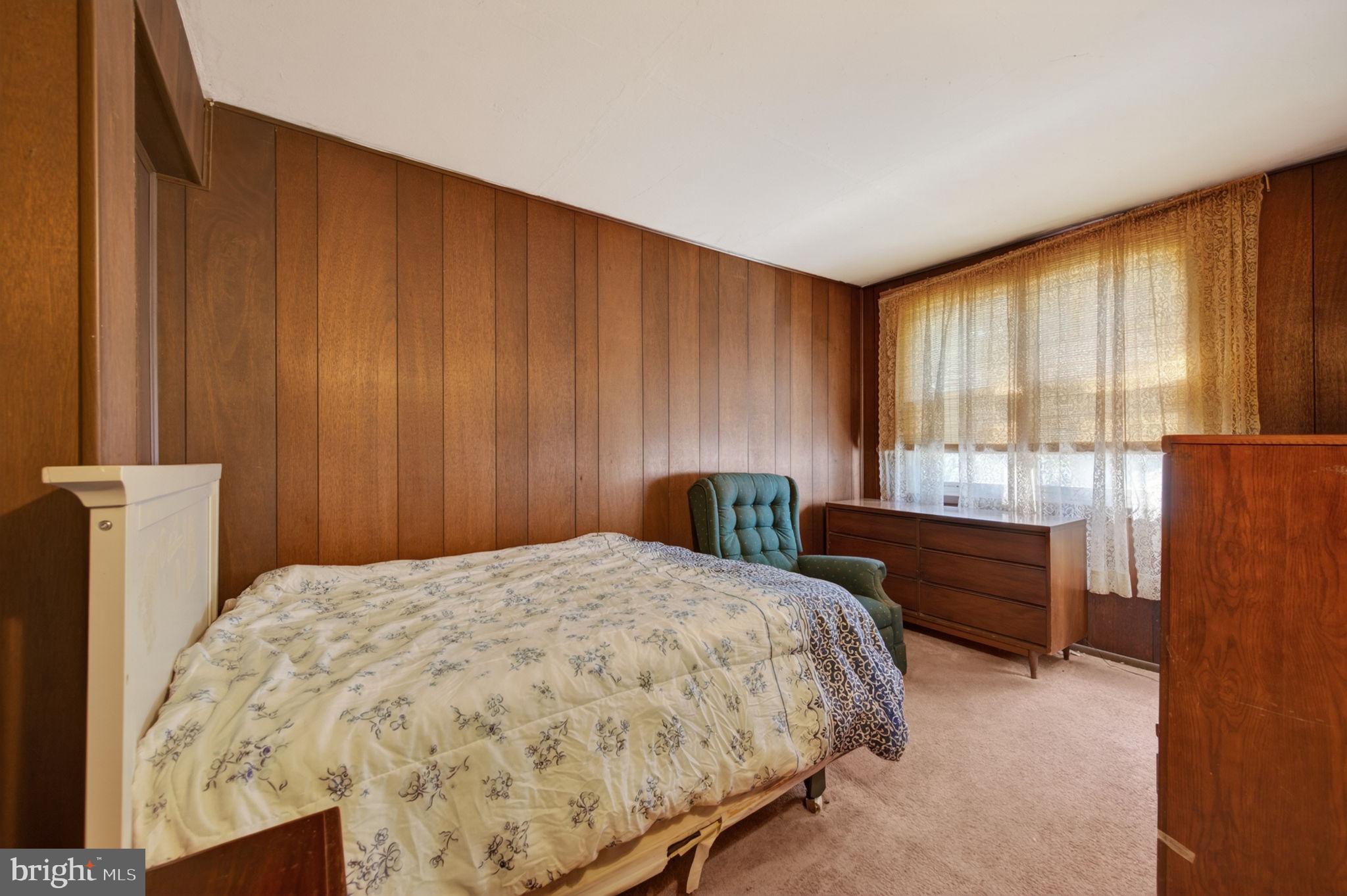 952 Armistead Way Baltimore, MD 21205 - Photo 7 of 13 a bed sitting in a spacious bedroom next to a window