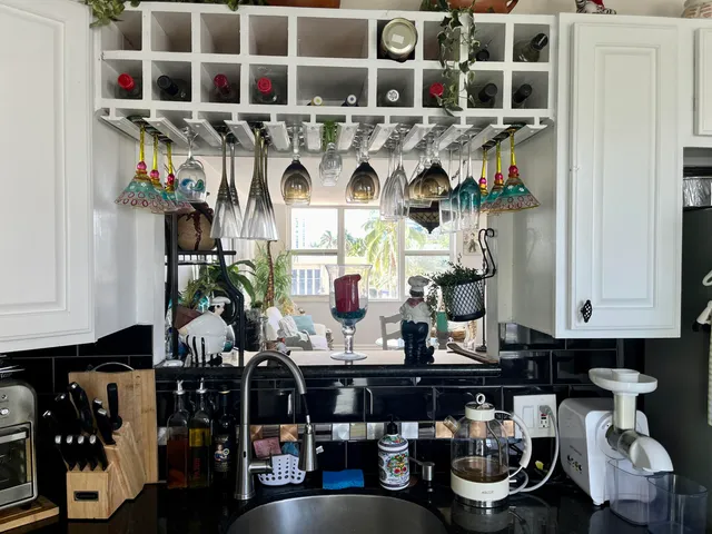 a kitchen area with granite countertop a white stove and cabinets