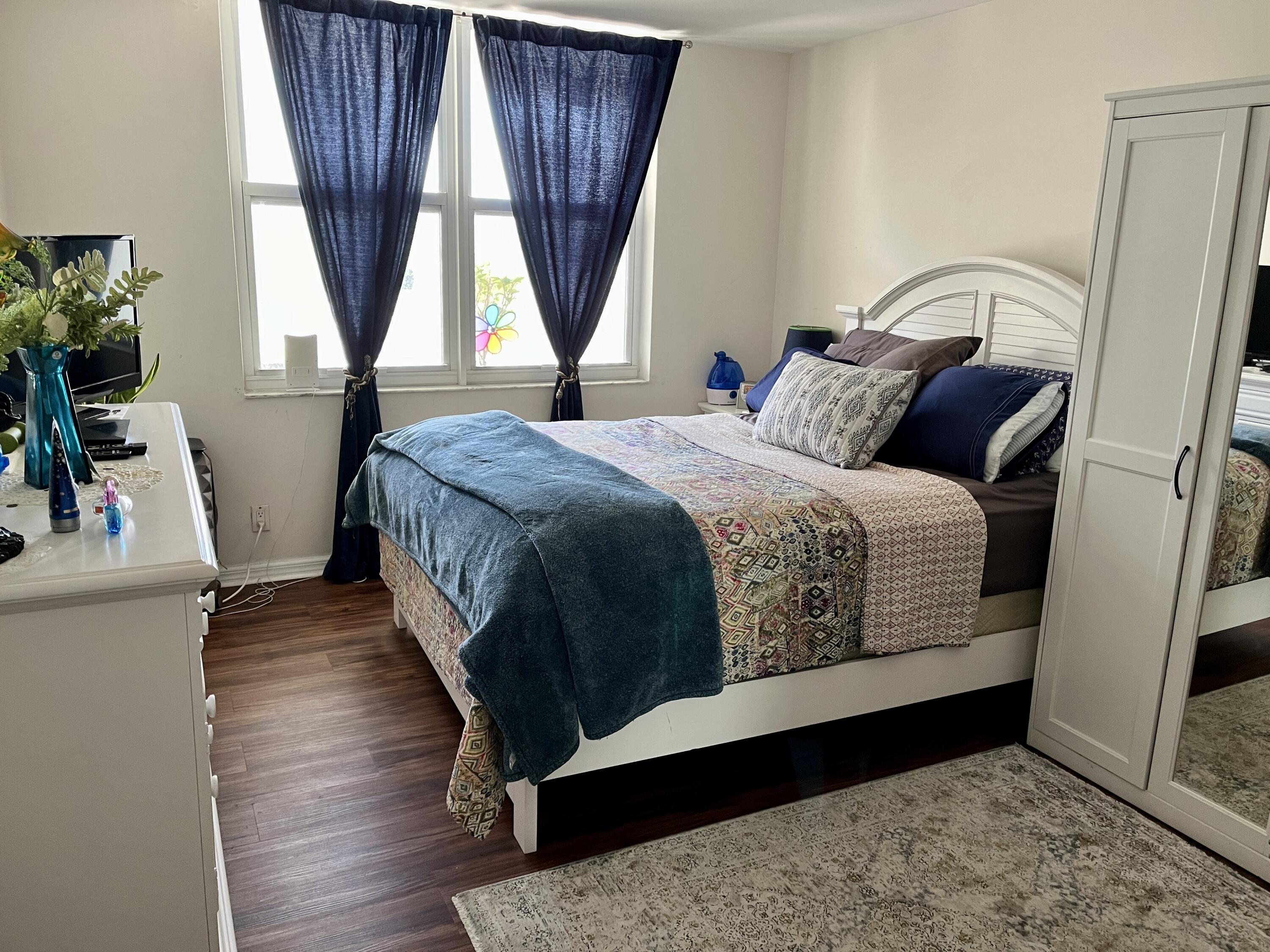 201 North Ocean Boulevard, Unit 302 Pompano Beach, FL 33062 - Photo 14 of 39 a bedroom with a bed a window and potted plant