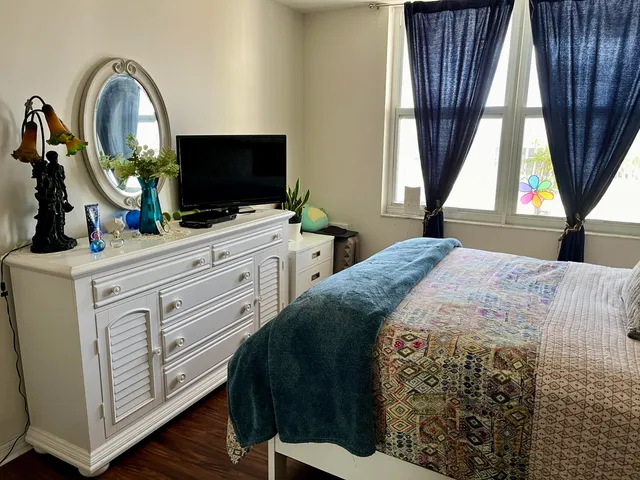 a bedroom with a bed and a flat screen tv