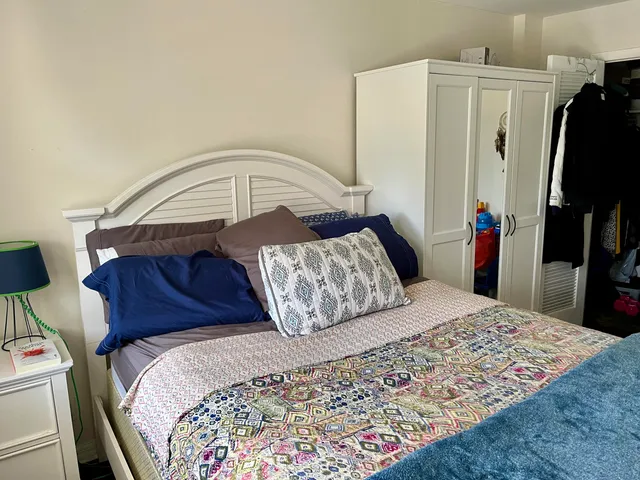 a bedroom with a bed and a mirror