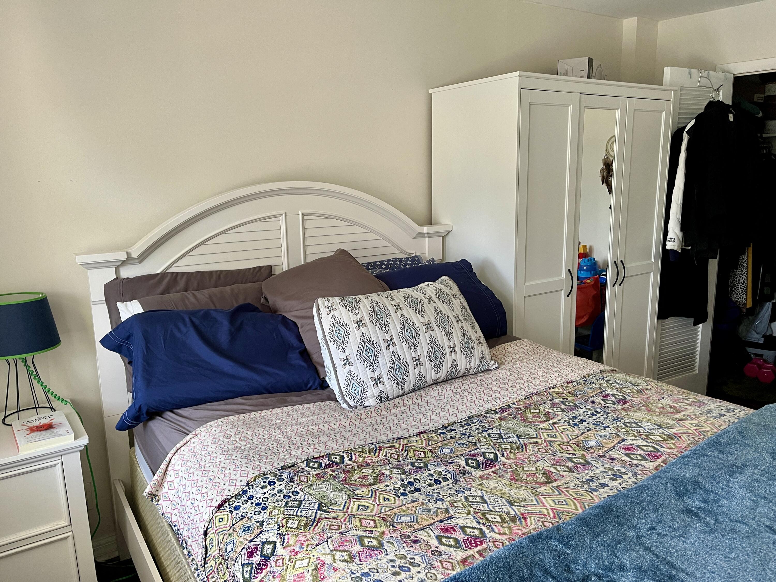 201 North Ocean Boulevard, Unit 302 Pompano Beach, FL 33062 - Photo 16 of 39 a bedroom with a bed and a mirror