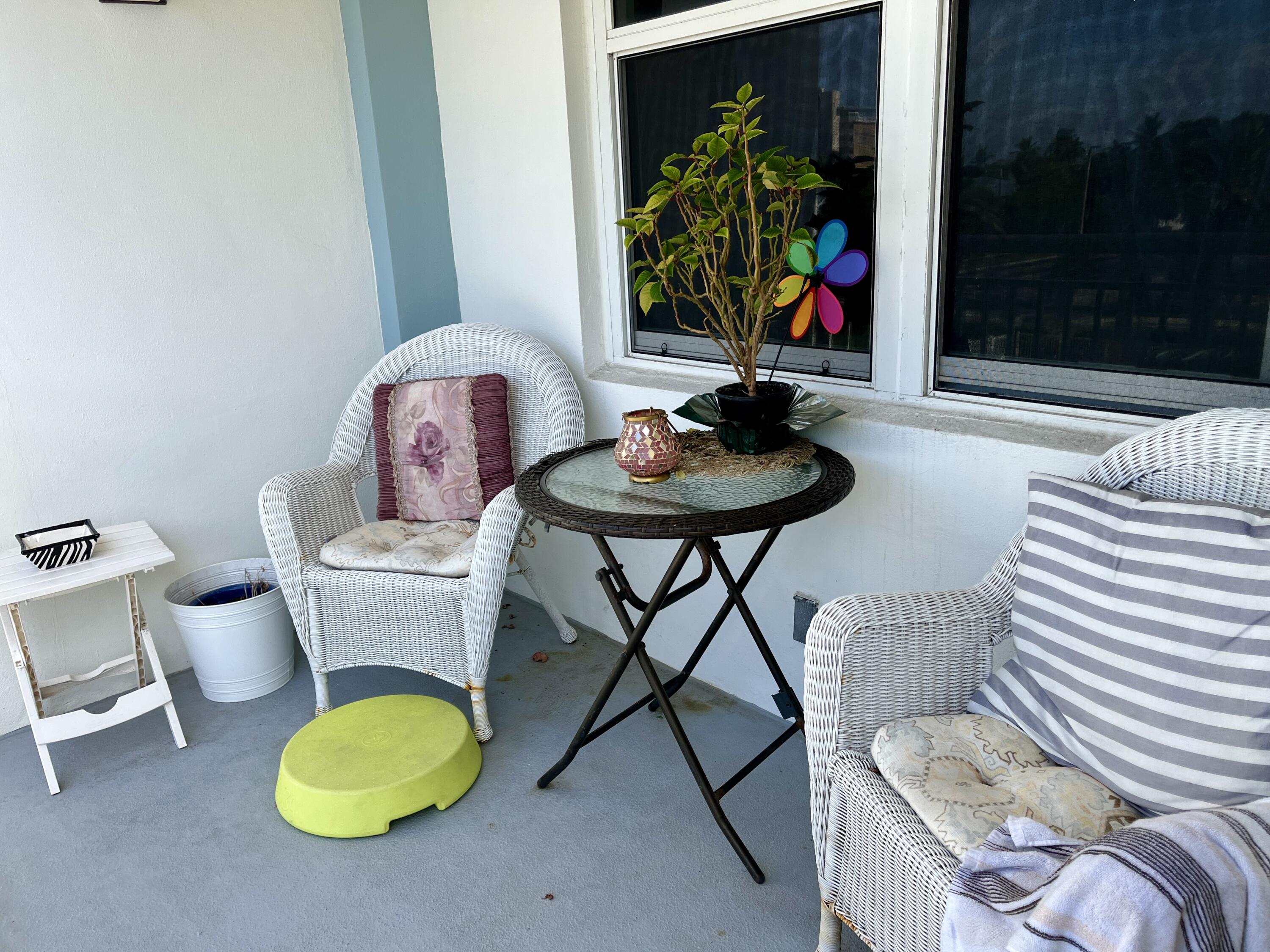 201 North Ocean Boulevard, Unit 302 Pompano Beach, FL 33062 - Photo 19 of 39 a living room with furniture and a floor to ceiling window