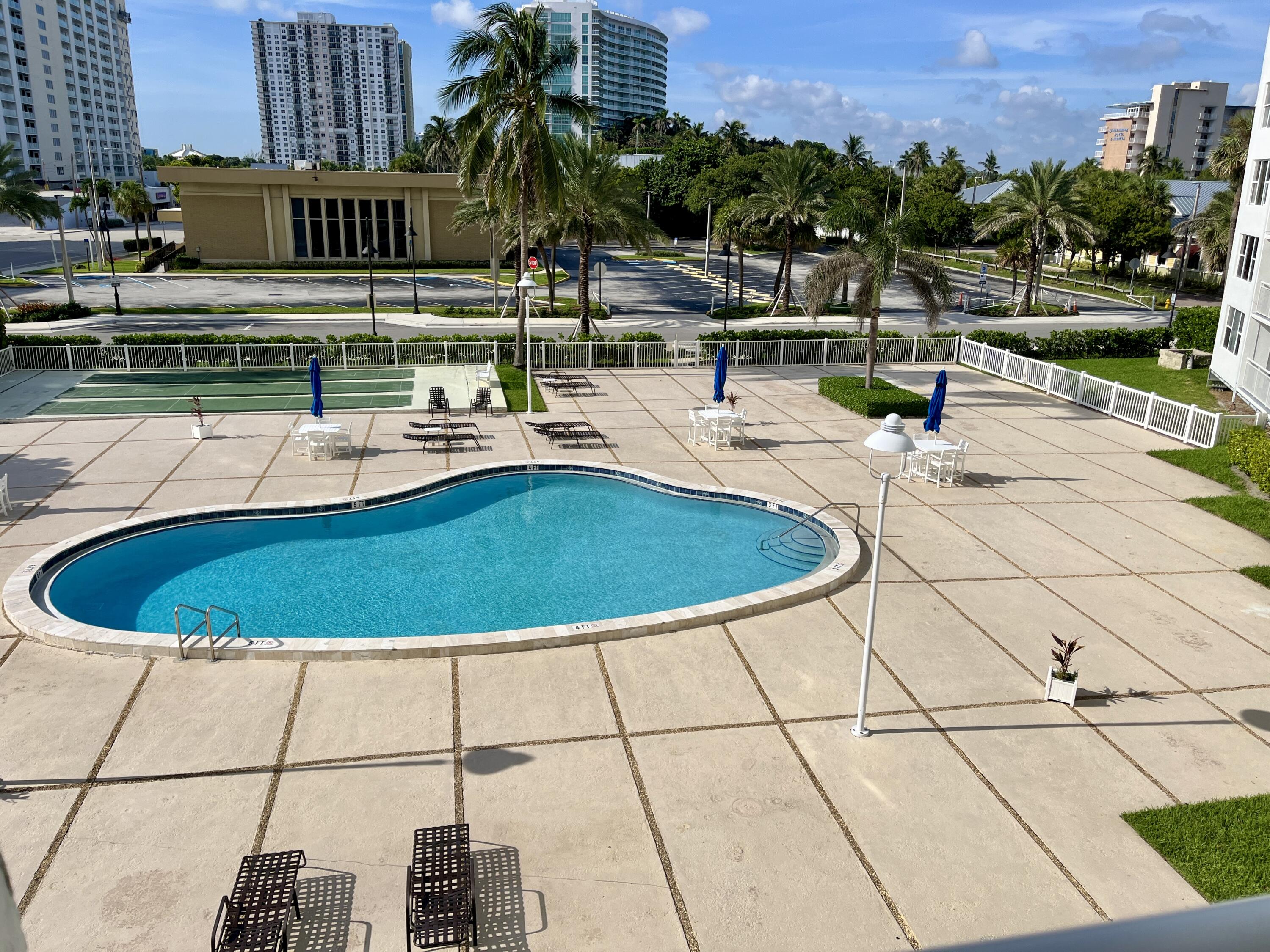 201 North Ocean Boulevard, Unit 302 Pompano Beach, FL 33062 - Photo 23 of 39 a view of a swimming pool with a patio
