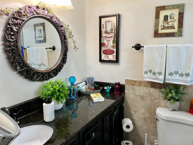 a bathroom with a granite countertop sink and a mirror