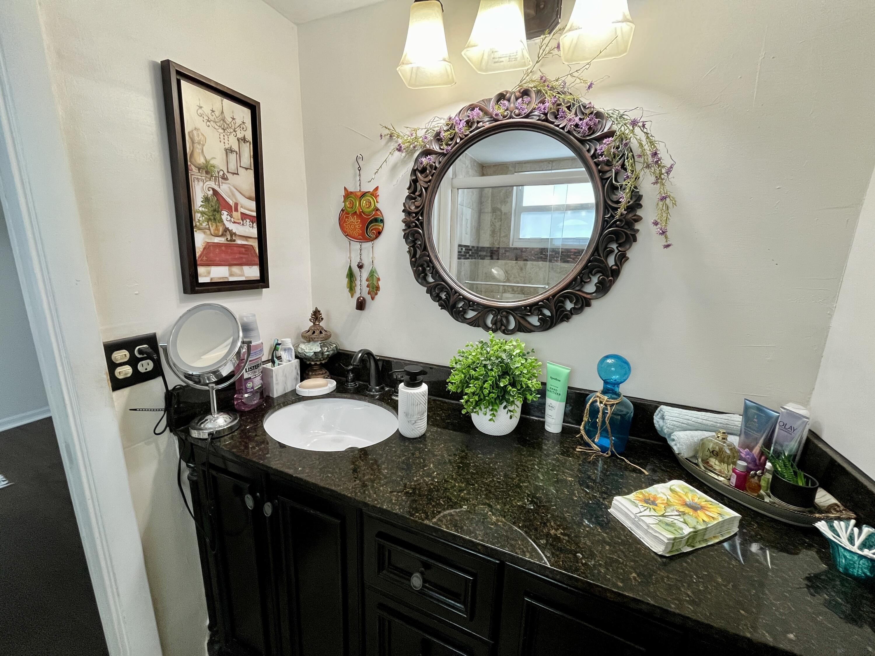 201 North Ocean Boulevard, Unit 302 Pompano Beach, FL 33062 - Photo 26 of 39 a bathroom with a granite countertop double vanity and a mirror