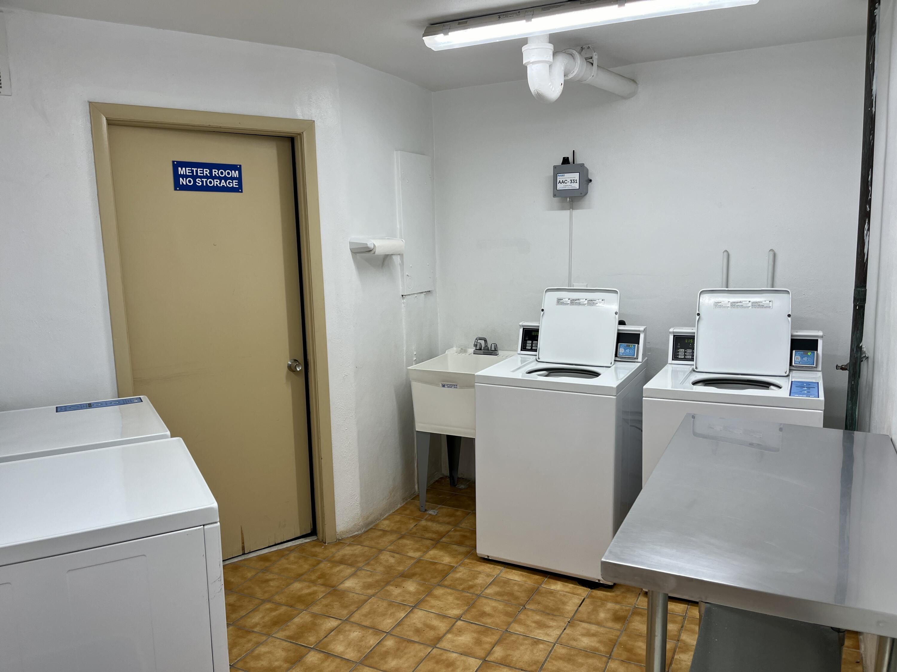 201 North Ocean Boulevard, Unit 302 Pompano Beach, FL 33062 - Photo 37 of 39 a room with a washer and dryer