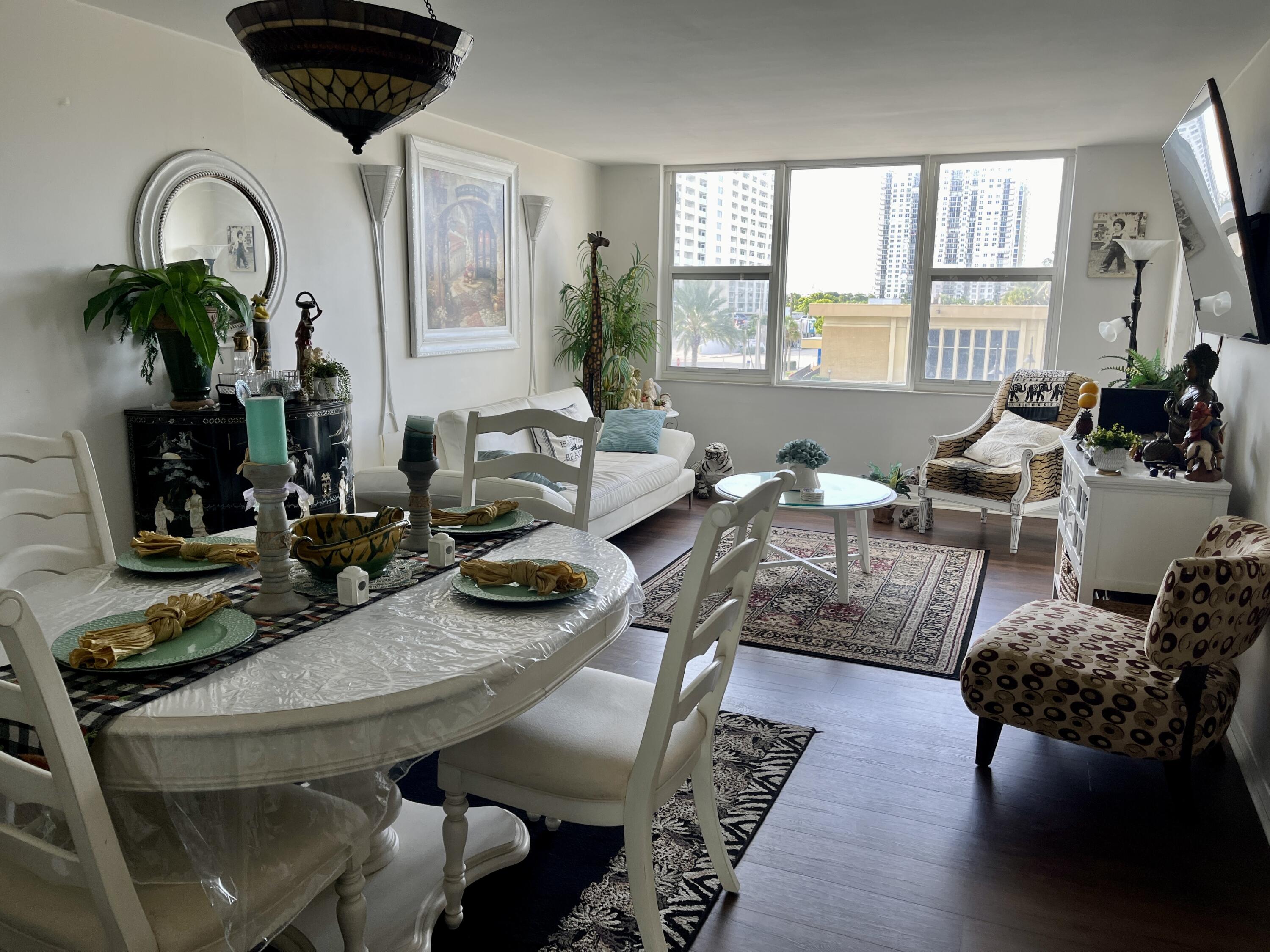 201 North Ocean Boulevard, Unit 302 Pompano Beach, FL 33062 - Photo 4 of 39 a living room with furniture and wooden floor